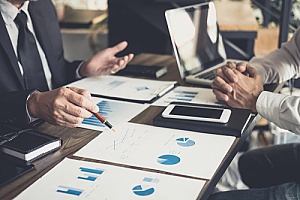 a banker speaking to a business owner regarding a business savings account