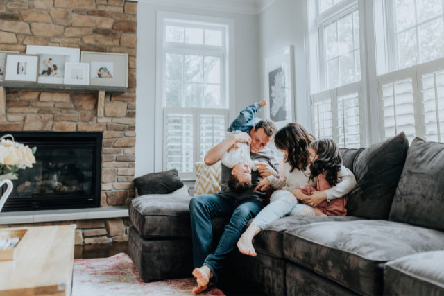 Family in living room who has personal insurance