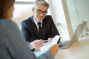 banker reviewing paperwork with client