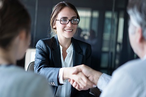 banker shaking hands with business owner clients