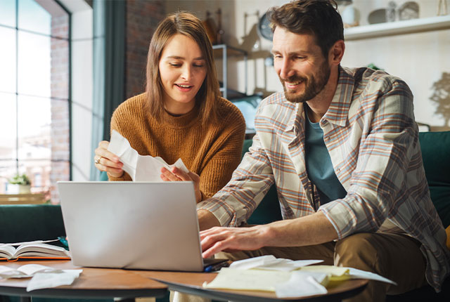 a man and women working on a computer for their business