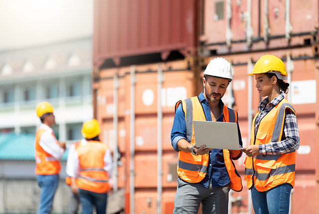 man and women at a control loading dock for shipping containers